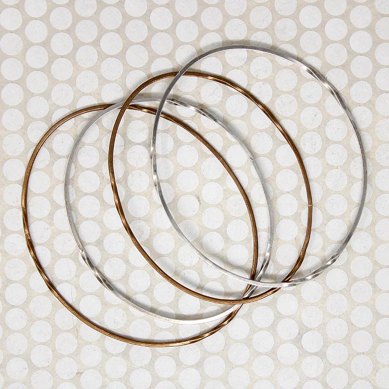 The Endless Twist Oval Bangle in Bronze from Allie B.