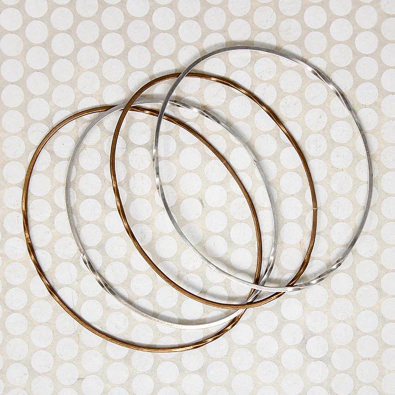 The Endless Twist Oval Bangle in Sterling from Allie B.