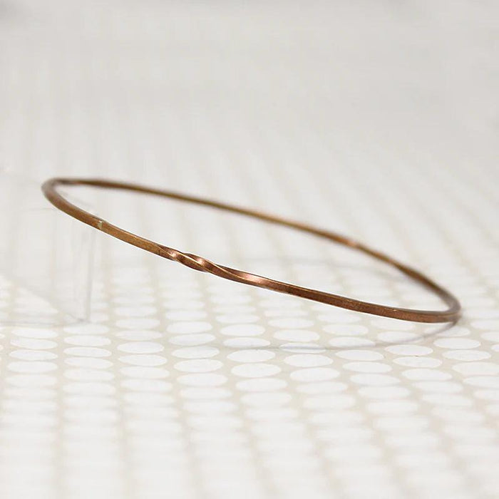 The Endless Twist Round Bangle in Bronze from Allie B.