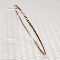 The Endless Twist Round Bangle in Bronze from Allie B.