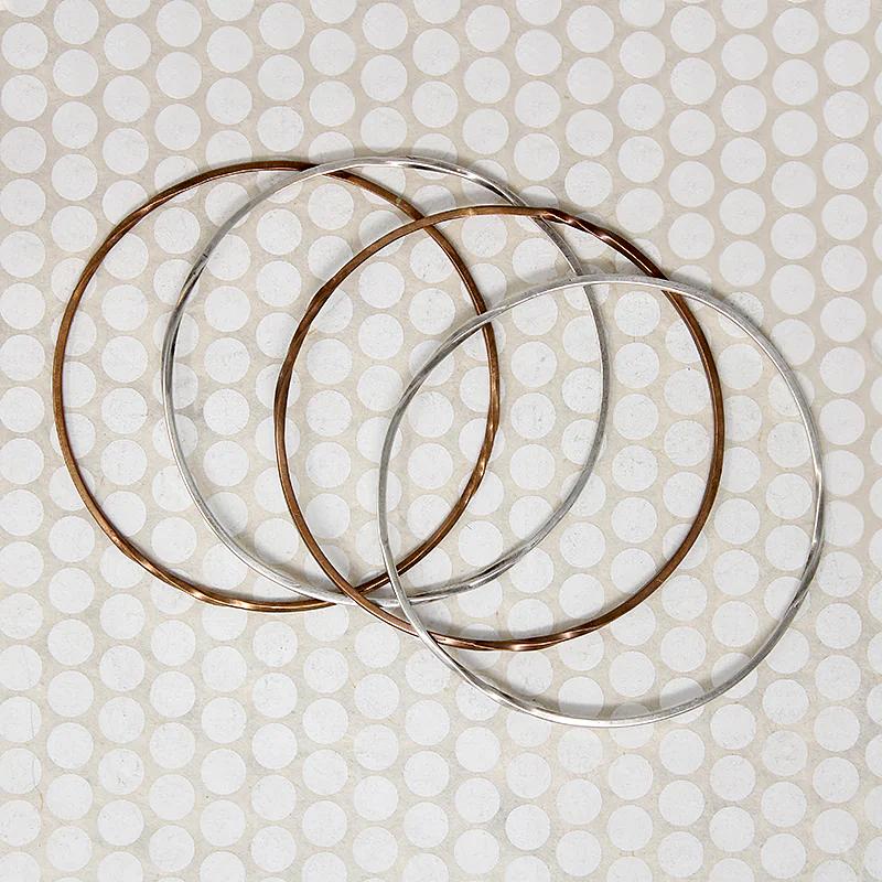The Endless Twist Round Bangle in Sterling from Allie B.