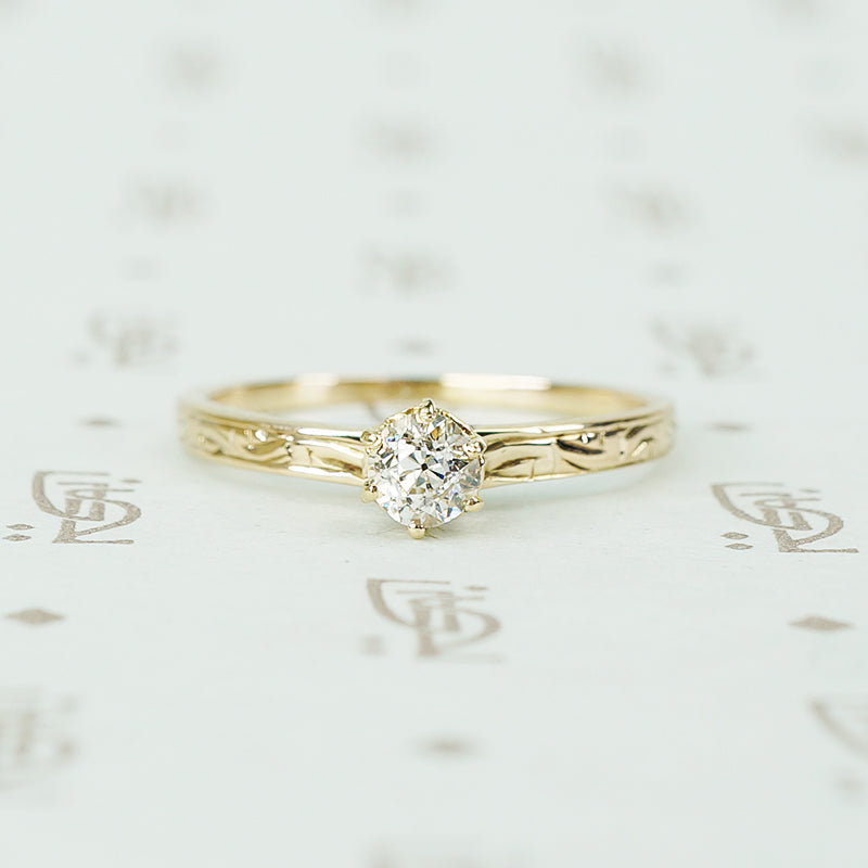 pretty antique engraved rose gold band solitaire with .29ct oec