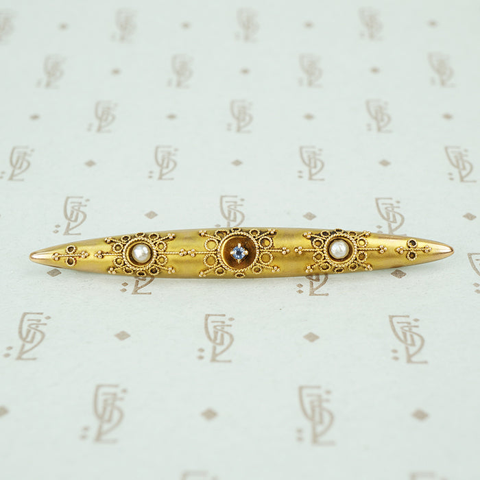 etruscan revival bar pin set with river pearls and montana sapphire