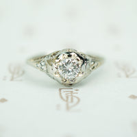 vintage 1920's 18k white gold filigree engagement ring with a .40 carat diamond set in a star 