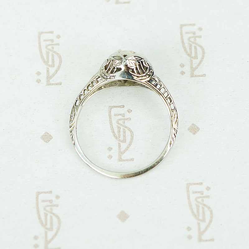 flat side view of 18k white gold vintage 1920's filigree diamond ring showing open work and filigree details