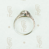 flat side view of 18k white gold vintage 1920's filigree diamond ring showing open work and filigree details