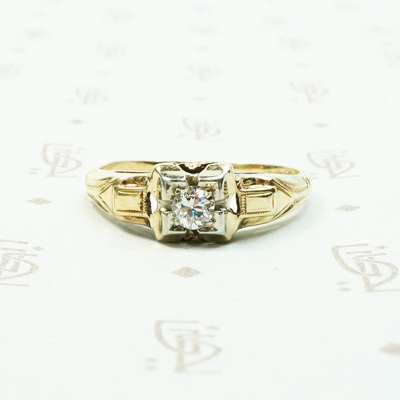 pretty 2 tone gold and diamond set engagement ring