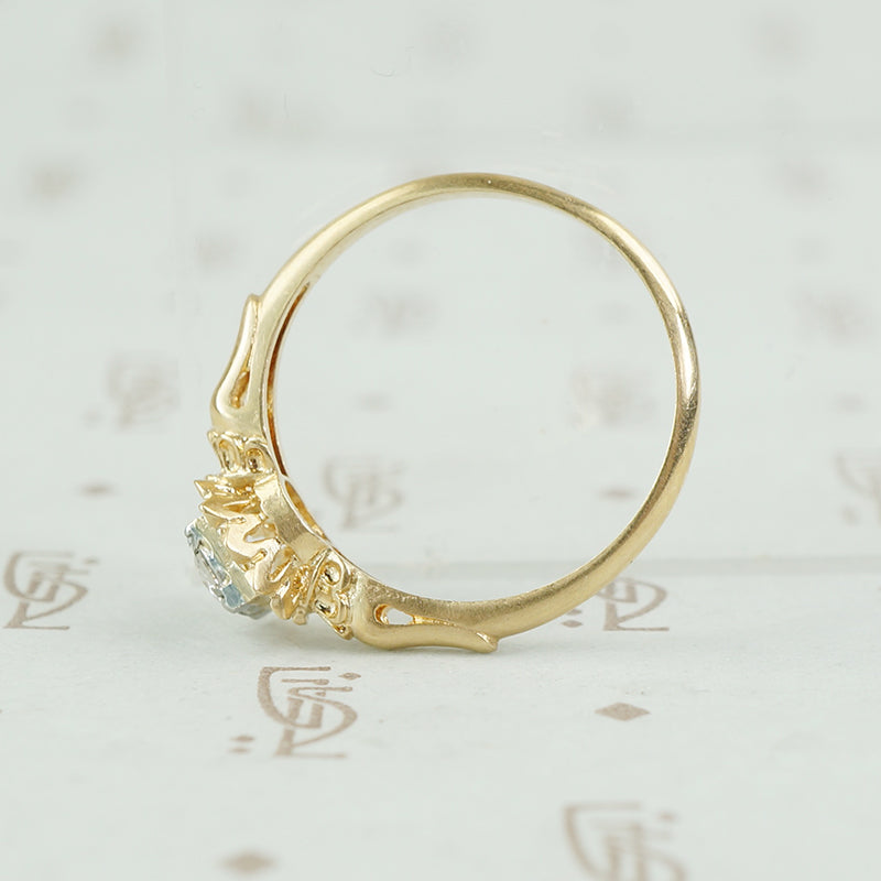 yellow gold flower holds white gold set diamond engagement ring