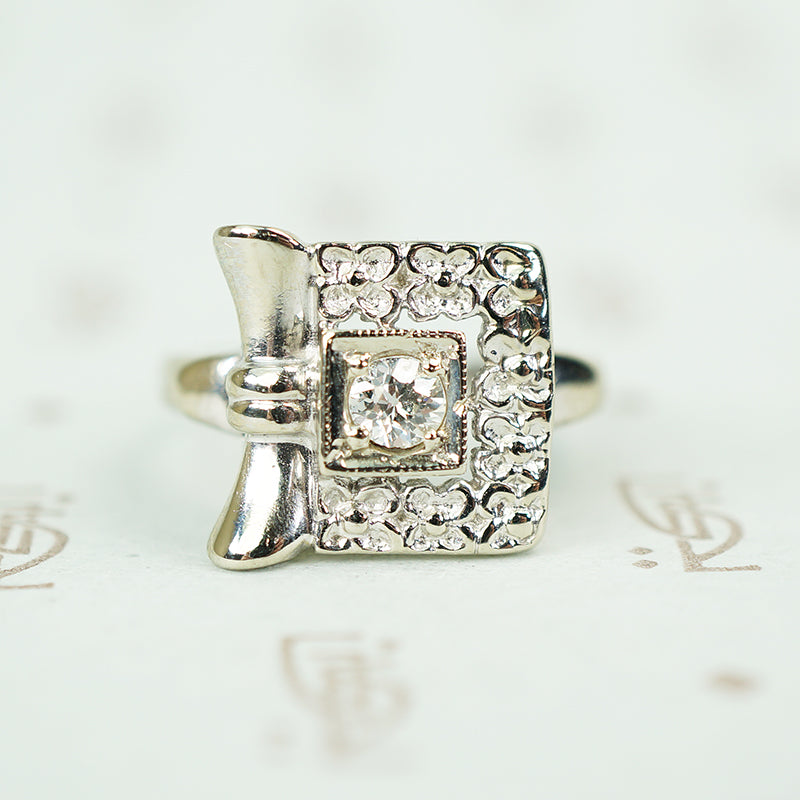 14k white gold square ring of forget me not flowers with .10 point diamond at the center