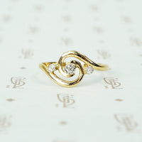 18k yellow gold swirl ring with tiny diamonds set in platinum french hallmarks