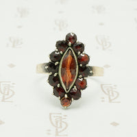 rose cut garnets in a vette shape with a gold band ring circa 1930