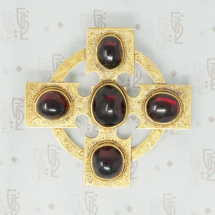 18k cross brooch set with garnet carbuncles