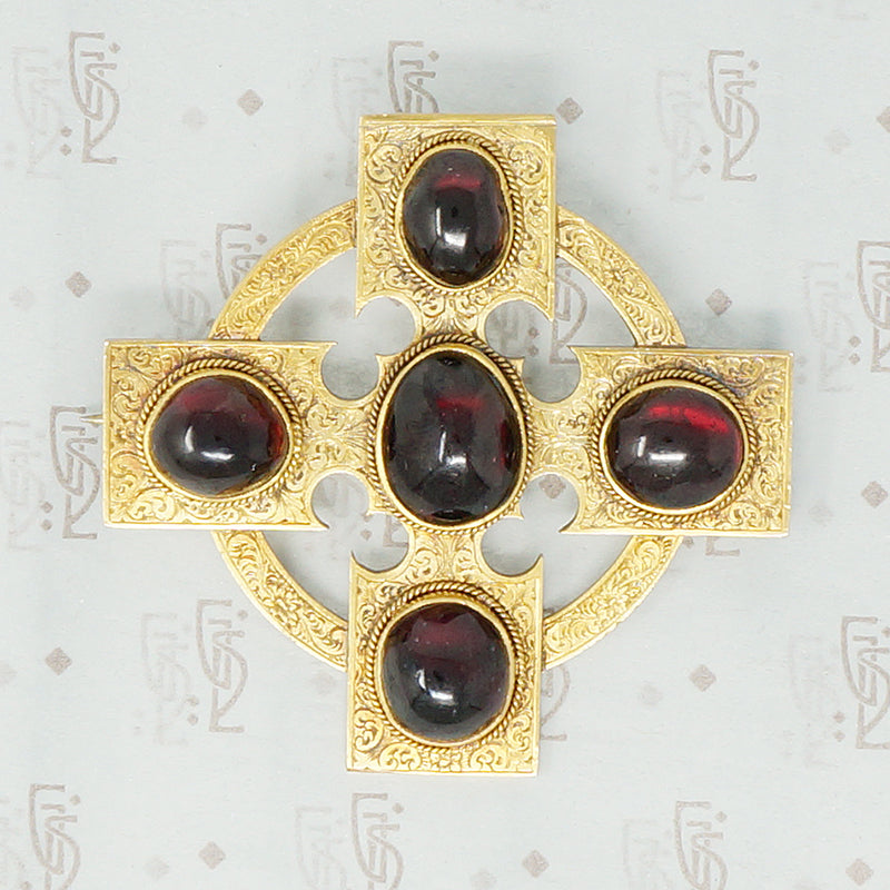 18k cross brooch set with garnet carbuncles