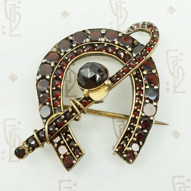Garnet horseshoe riding crop and jockeys cap brooch