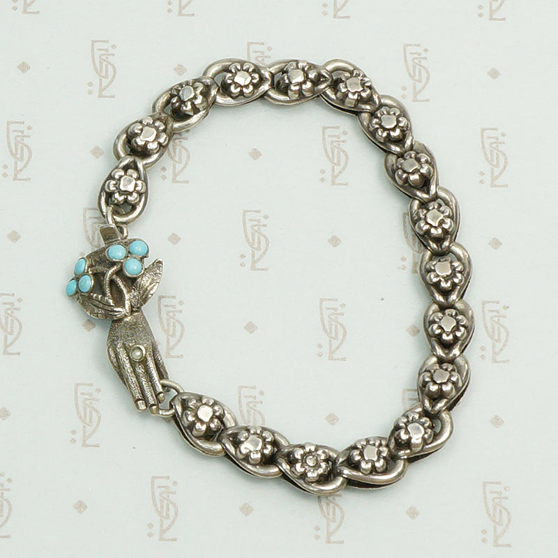 19th century silver flower link bracelet with a bejeweled hand clasp