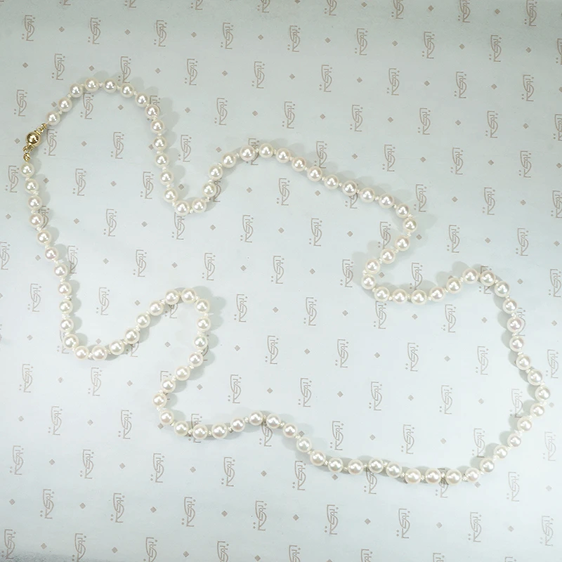 lovely long strand of pearls hand knotted on silk 28" with gold ball clasp