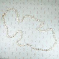 lovely long strand of pearls hand knotted on silk 28" with gold ball clasp