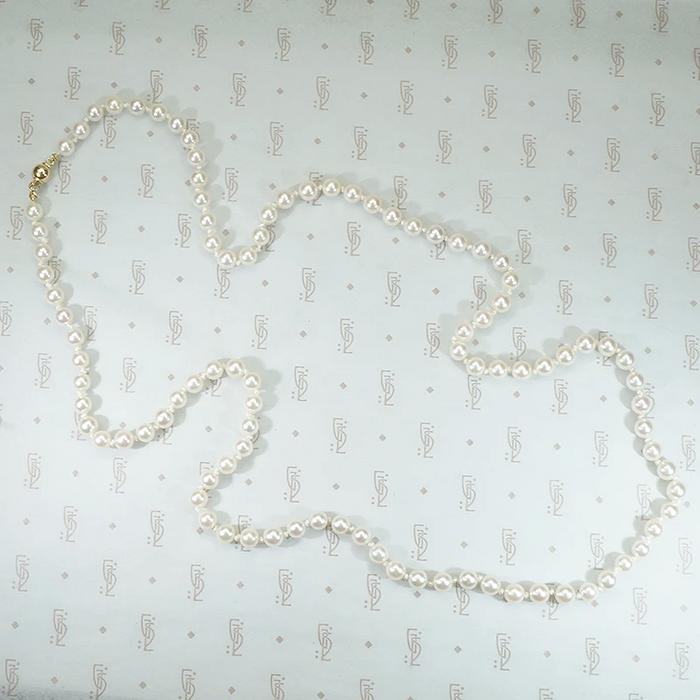 lovely long strand of pearls hand knotted on silk 28" with gold ball clasp