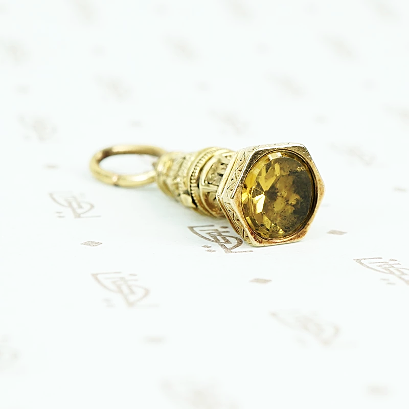 9ct fob with yellow glass stone