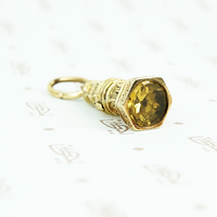 9ct fob with yellow glass stone