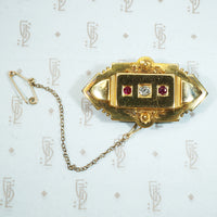 15k English Locket back brooch with original saety chain and omc diamond and rubies