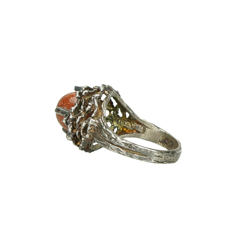 detail side view of floral 1960's sterling silver and goldstone ring