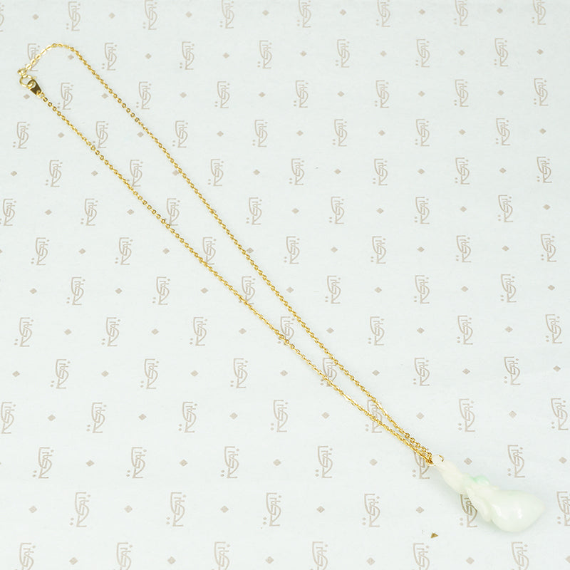 carved jade plum pendant on gold filled chain the jade is a pale celadon with a bit of apple green