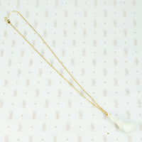 carved jade plum pendant on gold filled chain the jade is a pale celadon with a bit of apple green