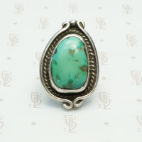 vintage 1970's green turquoise ring in coin silver with a snake like frame design, bold size