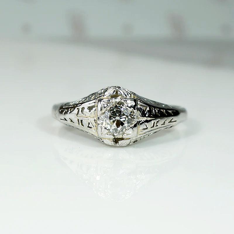 Ornate White Gold Solitaire Ring with Charming Old Diamond