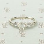 Refined Emerald Step-Cut Diamond Engagement Ring