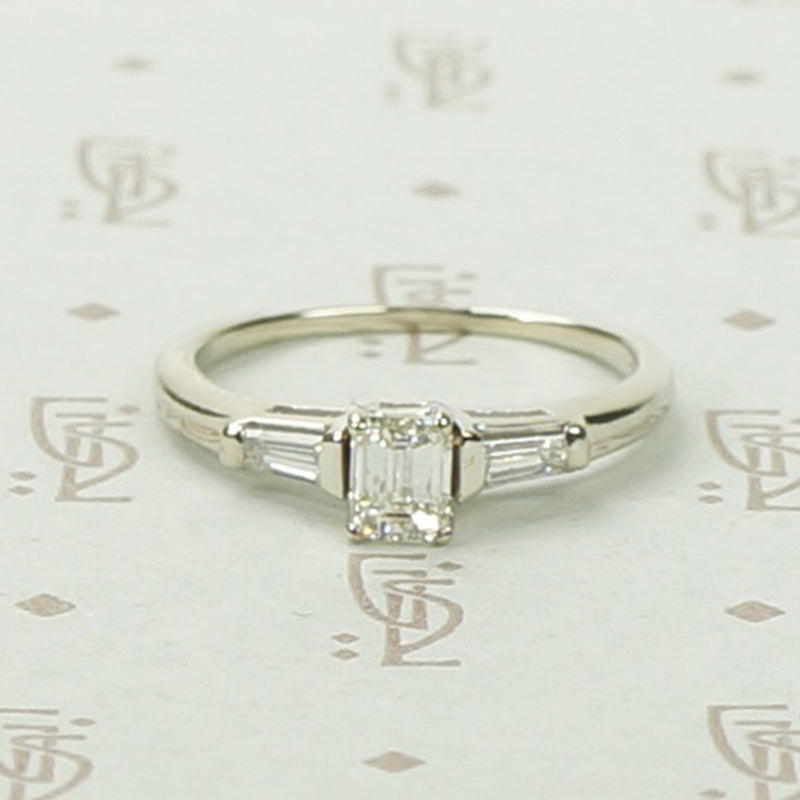 Refined Emerald Step-Cut Diamond Engagement Ring