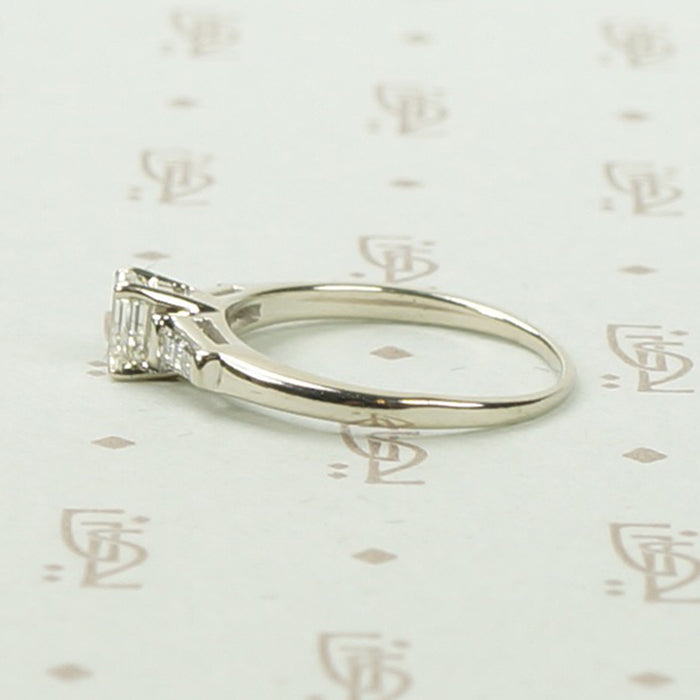Refined Emerald Step-Cut Diamond Engagement Ring
