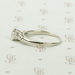 Refined Emerald Step-Cut Diamond Engagement Ring