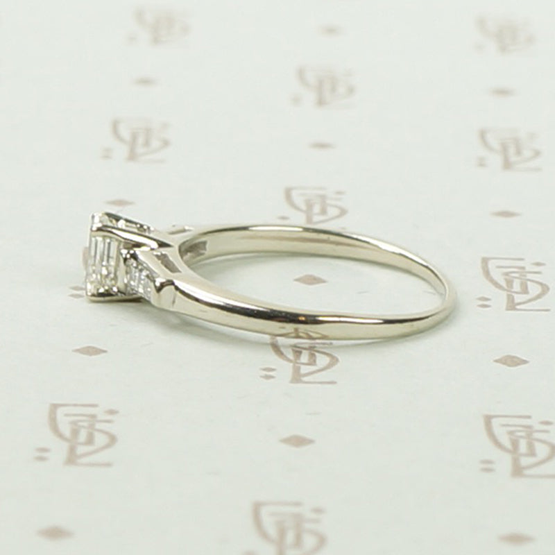 Refined Emerald Step-Cut Diamond Engagement Ring