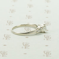 Refined Emerald Step-Cut Diamond Engagement Ring
