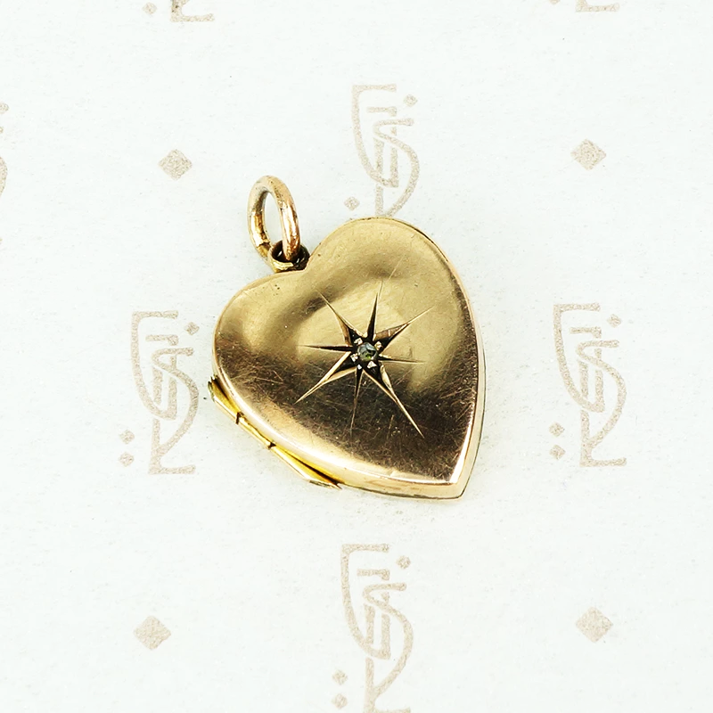 heart shaped antique locket with a star set rose cut diamond