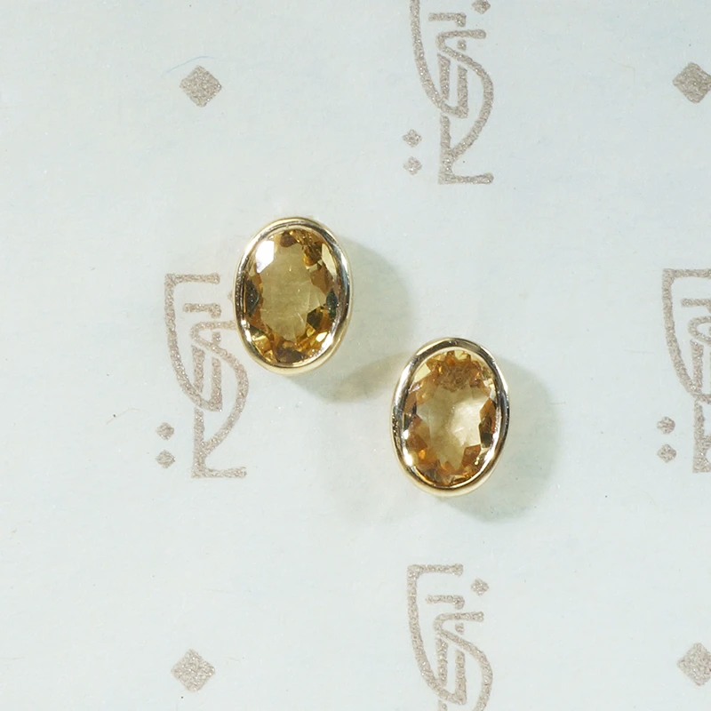 oval bezel set imperial topaz recycled 14k yellow gold stud earrings