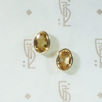 oval bezel set imperial topaz recycled 14k yellow gold stud earrings
