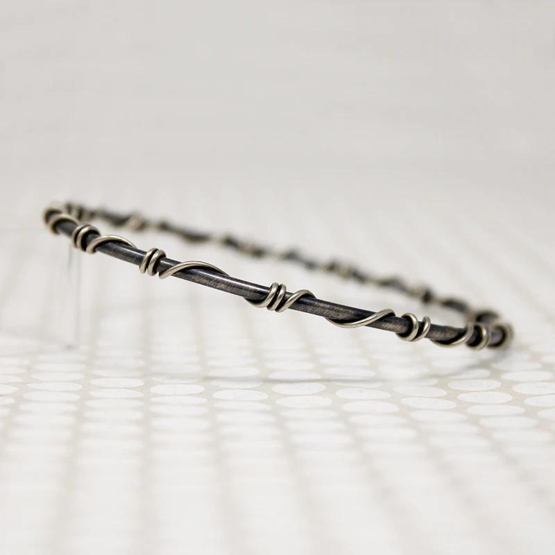 The Infinity Twist Silver Bangle from Allie B.