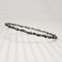 The Infinity Twist Silver Bangle from Allie B.