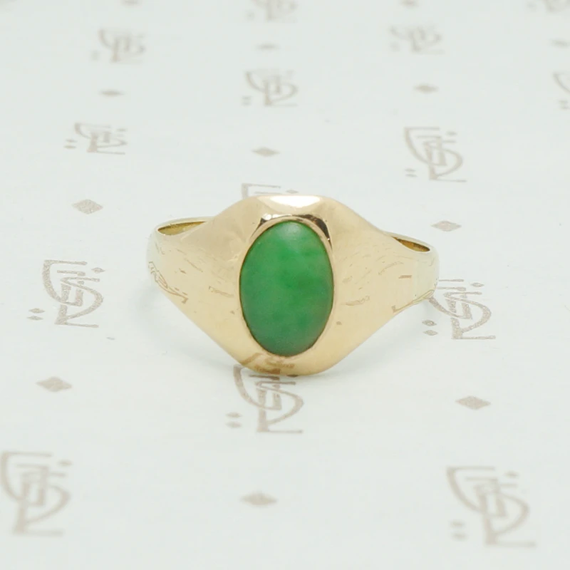 10k yellow gold tapering curved front gypsy ring set with an oval grass gree jade stone