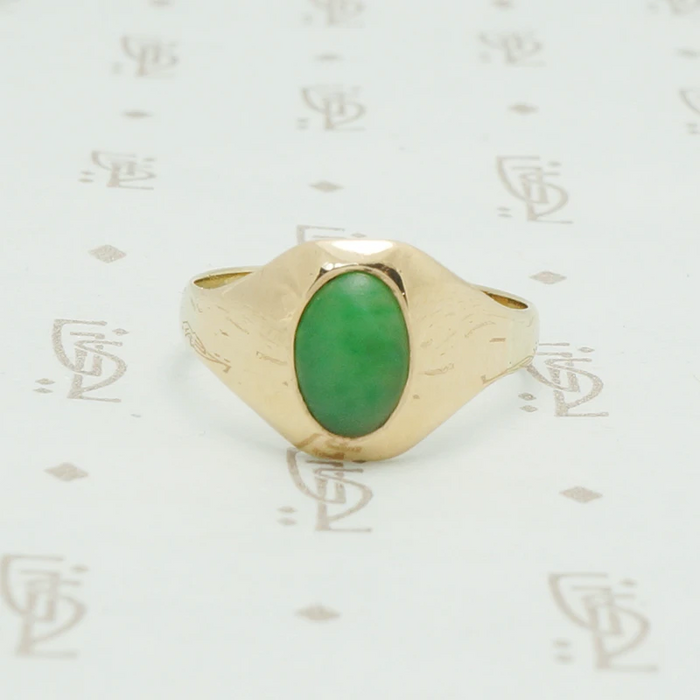 10k yellow gold tapering curved front gypsy ring set with an oval grass gree jade stone
