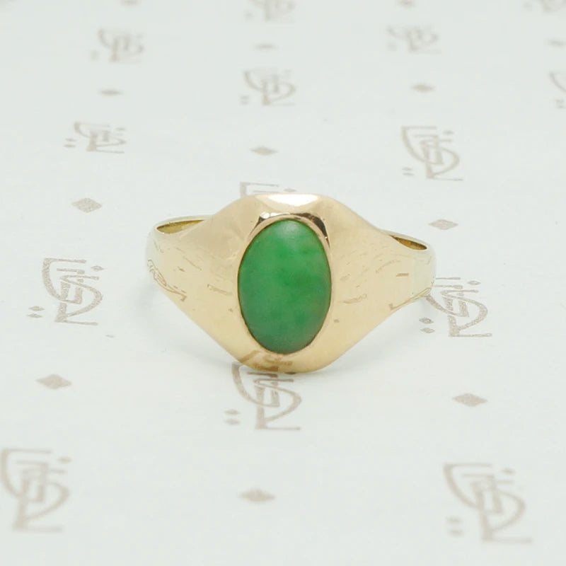 10k yellow gold tapering curved front gypsy ring set with an oval grass gree jade stone