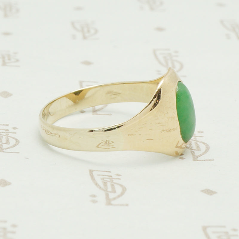 10k yellow gold tapering curved front gypsy ring set with an oval grass gree jade stone
