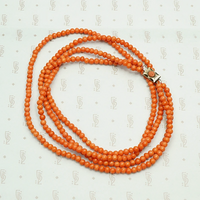 Delicate Two Strand Antique Red Coral Beads. Coiled view.