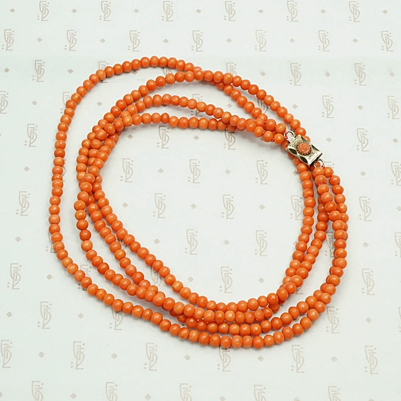 Delicate Two Strand Antique Red Coral Beads. Coiled view.