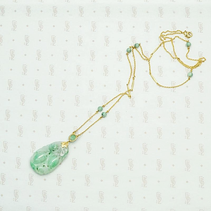 Carved Jade Plum Pendant on Decorative Gold Chain. Back view.