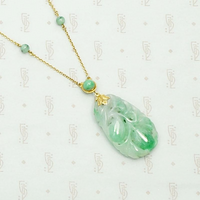 Carved Jade Plum Pendant on Decorative Gold Chain. Detail view.