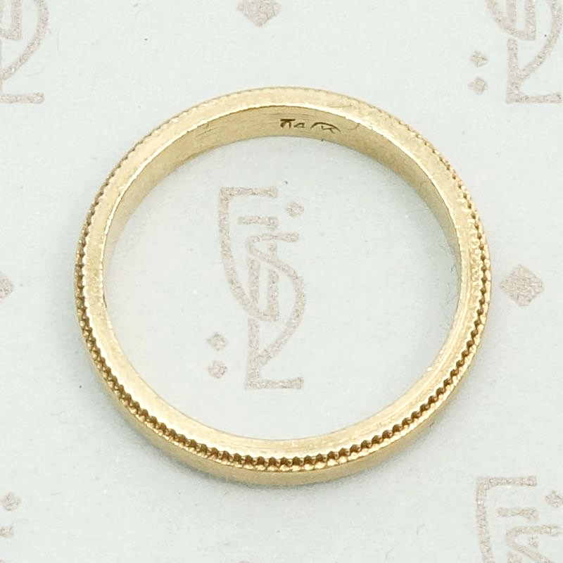 Heavy Vintage Gold Band with Sawtooth Edge, top view.